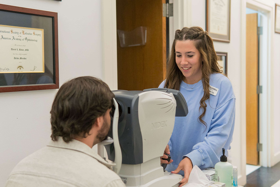 a tech helps a patient with medical equipment